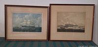 Both framed prints standing side by side