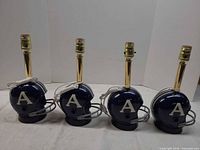 Front view of four Toronto Argonauts helmet lamps showing side logos