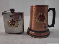 Flask and stein front view showing Soviet emblems