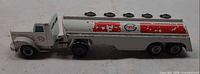 Left side view of Tekno Esso tanker truck showing cab, tank and paint wear