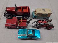 Group shot of all five vehicles displayed on flat surface