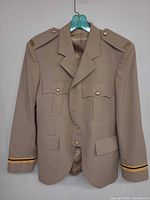 Front of jacket showing pockets, buttons, epaulettes, cuff braid