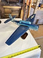 Left-front view of diecast Avenger on stand with tape measure showing wingspan