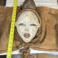 Front view of mask with tape measure showing length