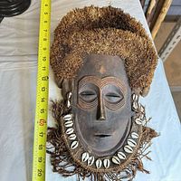 Front view showing full mask next to tape for size reference