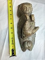 Full figurine beside tape measure showing ~13 inch length