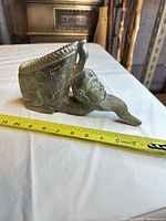 Right side view showing horn form, face and measuring tape indicating length