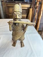 Front view of brass tribal musician figurine