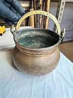 Top view showing interior verdigris, swing handle, etched rim decoration