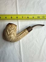 Full view of pipe alongside ruler showing length approx 7 in