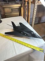 Full view of model with tape measure showing length near 17 inches
