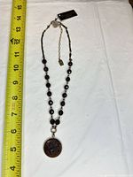 Full view of Compass Rose Design necklace with tape measure showing approx 15 in. length