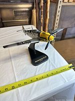 Front angle view on stand with tape measure showing size