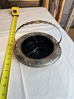 Top view showing full dish, handle up, and measuring tape indicating size