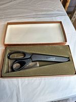 Closed presentation box with scissors and contents