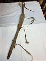 Full view of pipe tomahawk showing blade, shaft, fur trim and tassels