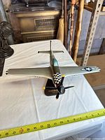 Oblique front view showing overall model, stand, ruler indicating wingspan