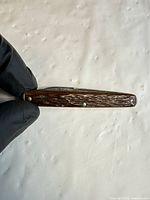 Closed knife showing jigged brown bone handle