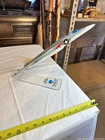 Side view of RA-5C Vigilante model on acrylic stand with tape measure indicating length