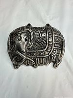 Front view of silver-plated elephant brooch showing detailed motif