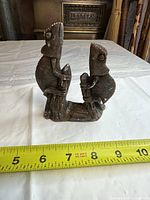 Front view of ceramic twin chameleon figurine with measuring tape for scale