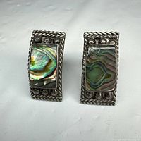 front view of both earrings showing abalone inlay and border detail