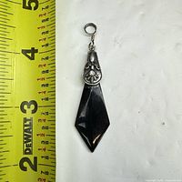Full pendant beside ruler showing length ~2.6 in