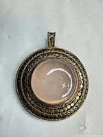 Front view showing rose quartz cabochon and silver detailing