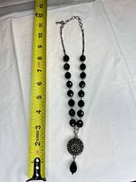 Full necklace beside tape measure showing length
