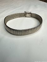 Top view of entire bracelet showing mesh weave and clasp