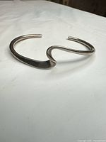 Top view of sterling silver open cuff bracelet showing wave design