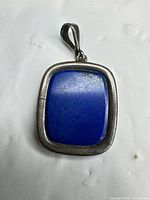 Front view of sterling silver pendant with blue stone