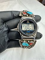 Front view of Timex Atlantis 100 showing digital display, sterling silver overlay with turquoise and coral stones