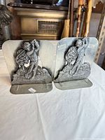 Front view of both bookends showing golfer relief and overall design