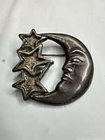 Front view showing crescent moon face and three stars design