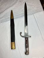 Bayonet and scabbard full view on table