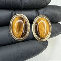 Front view showing both oval tiger’s eye earrings
