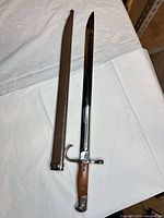 Full view of bayonet alongside scabbard