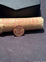 Coin beside original bank roll wrapper