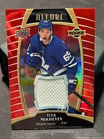 Front of card showing design, jersey swatch and player photo