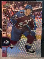Front of 2022-23 Upper Deck Tim Hortons Nathan MacKinnon card showing holographic image and card number