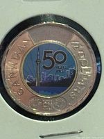 Reverse of coloured 2026 CN Tower 50 th Anniversary $2 coin in cardboard holder