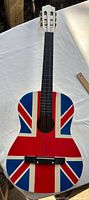 Full front view of 38-inch classical guitar showing Union Jack graphic, fingerboard and headstock