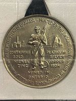 Obverse of medal showing miner, factory, metal list and surrounding legend