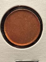 Obverse side of copper blank planchet in 2×2 holder