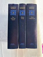 Spines of all three hardcover books showing titles and publisher