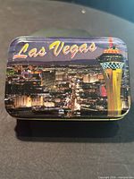 Closed tin showing Las Vegas skyline and logo