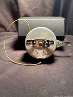 Front view of Shakespeare OK Automatic fly reel with handle and yellow line