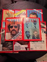 Group shot of nine vintage Time magazines spread out on table