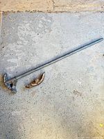Full view of wrench head on long handle with separate jaw piece